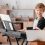 Little boy taking music lessons online at home